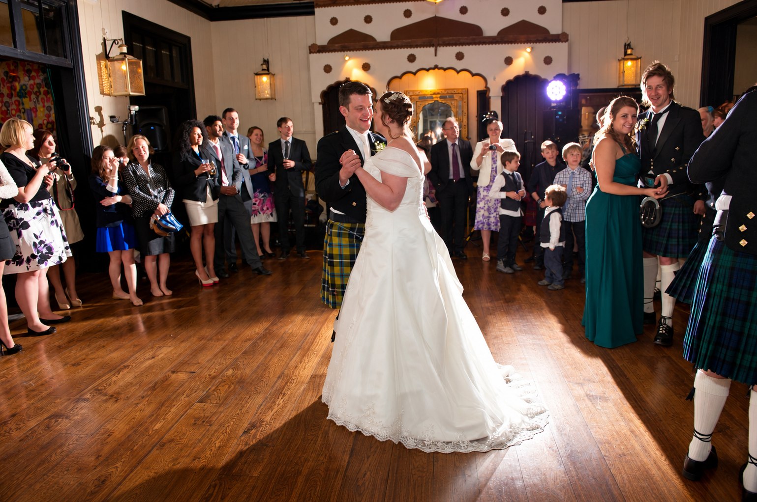 Bride and groom surrounded by guests during their wedding disco first dance