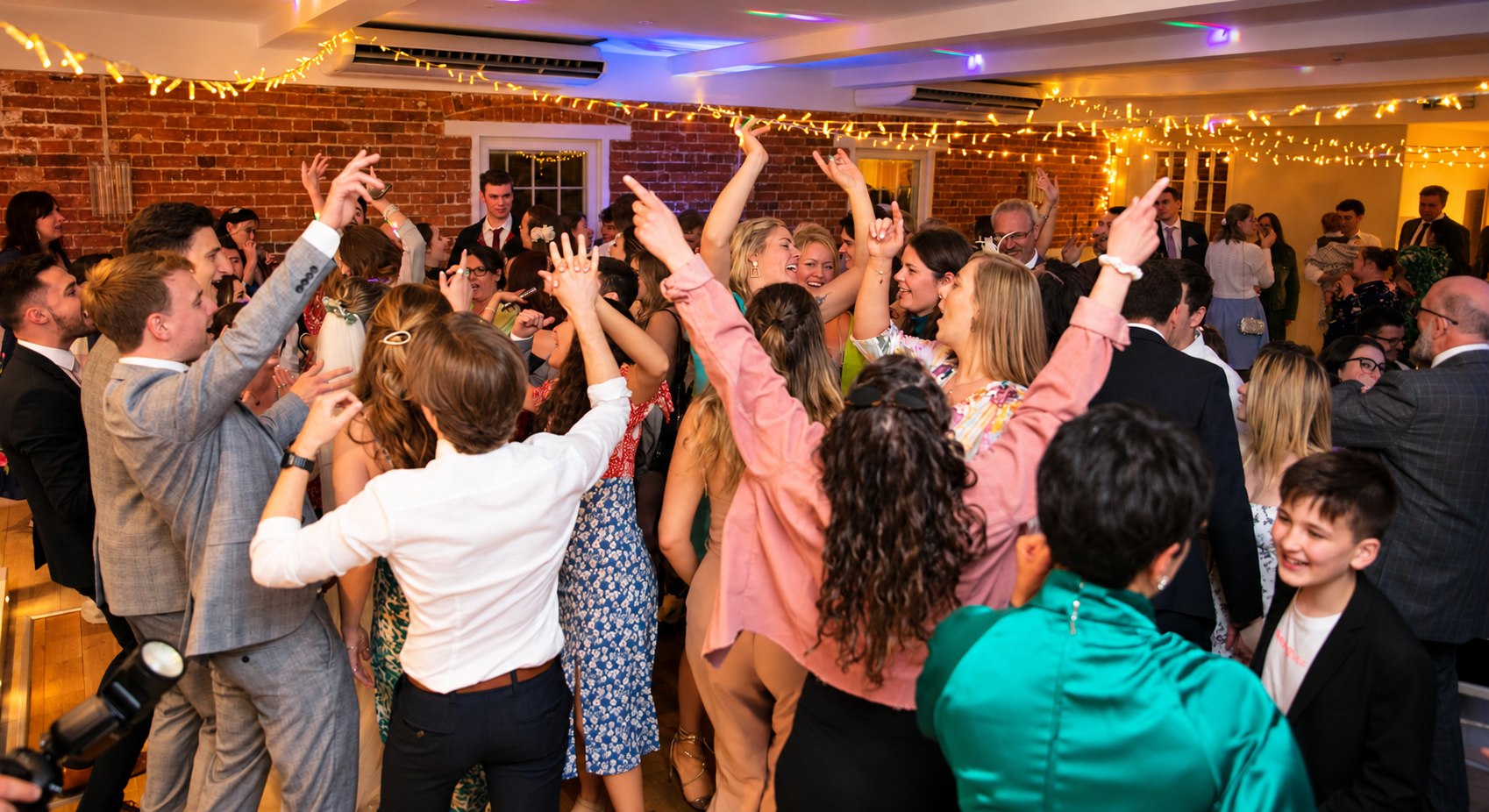 Wedding guests dancing at a We Perform wedding disco in Dorset
